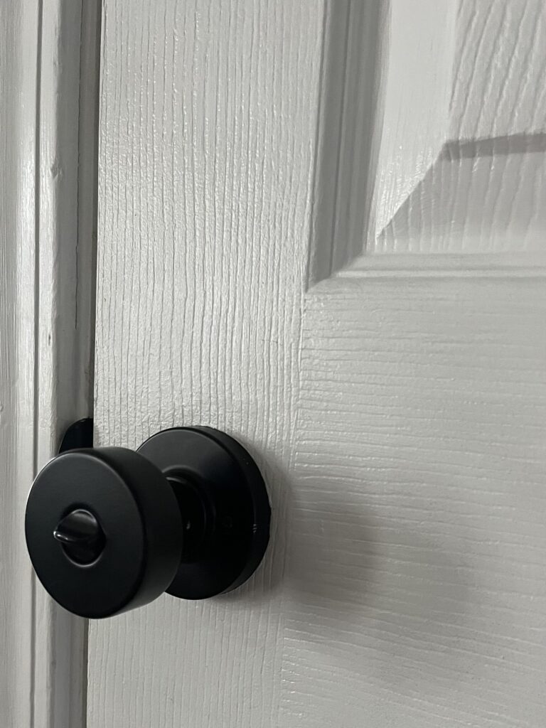 Black modern bedroom door knob installed by Tussel Home Remodeling's Handyman Division in Strongsville, Ohio